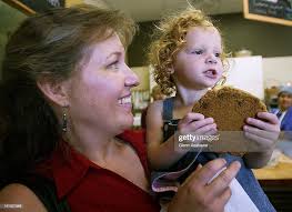 Denver author Carolyn Sutton holds Kate Prazak who was just given a... News  Photo