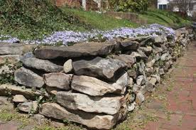 The main wall is limestone with local rounded granite fieldstones that were found on site to represent the leaves. How To Build A Stone Retaining Wall