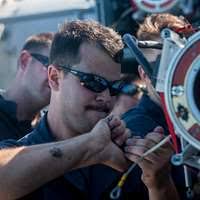 AIRMAN 1ST Class Robert Orfino, fireman from the 48th Civil Engineering  Squadron, Lakenheath Air Base, England, gets a haircut by SPC. Jeffrey  Clyons, 3/525th Airborne Combat Team (ABCT), Vicenza, Italy, inside the