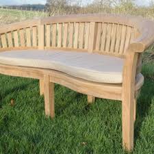 The piece includes 2 chairs joined by a central table which has an underlying shelf. Cushions Rattan And Teak Furniture