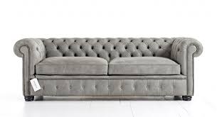 Dark gray chesterfield sofa designed with a square lucid coffee table in a contemporary living room both stingray millwork wall moldings and blue and gray abstract wall art. Grey Leather Couches Distinctive Chesterfields
