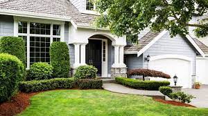 The left and middle sides are the concrete driveway and walkway flanked with flowering shrubs and the right side is a lush lawn of grass. Front Yard Landscaping Ideas To Try Now Before It S Too Late Realtor Com