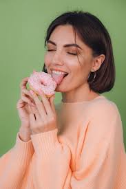 Young stylish woman in casual peach sweater isolated
