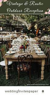 Vintage Rustic Wedding Reception With Floral Centerpieces And Retro Chairs Wedding Themes Rustic Wedding Themes Outdoor Rustic Wedding