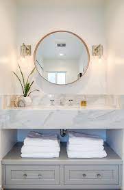 Modern powder room with floating dark wood vanity and bronze accents. Gray Drawers Under Floating Marble Sink Vanity Transitional Bathroom