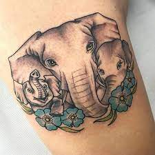 The elephant design symbolizes power, strength, spiritual symbol and other cool virtues. Elephant Family Tattoo With Flower Designs Elephant Family Tattoo Cute Elephant Tattoo Elephant Tattoos