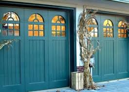 The tuscan garage door design complements the stone construction of the home with the rustic wooden header beam that was stained to match the custom wood garage. Traditional Style Garage Doors Historic Entry Doors Cambek