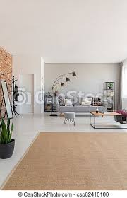 Combining oranges, whites and browns with your tan leather sofa is a fantastic way to warm up the look of a living room in a contemporary home. Beige Carpet In Modern Living Room Interior With Grey Couch Industrial Wooden Coffee Table And Stylish Lamp Real Photo With Canstock