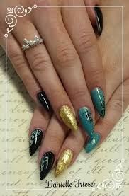 Black And Teal Stiletto Nails Trabbit Nail Creations Teal Black And Gold With Hand Painted Accents Teal Black Gold Stilettonails Gelnails Bling Foi Nails Gel Nails Stiletto Nails