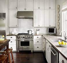 Camel leather counter stools are placed on a polished concrete floor at a white and black kitchen island lit by a brass linear light. 75 Beautiful Traditional Kitchen With Concrete Countertops Pictures Ideas June 2021 Houzz