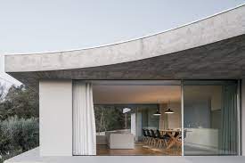 Minimalist house designs are often about keeping the focus on nature. Bdarquitectura Designs Minimal House With Flat And Curved Forms In Portugal Ignant