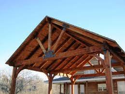 Custom 18' x 22' cedar gable pavilion shown with closed gable, no deck, 8/12 roof pitch, 16 post trim, 8x8 cedar wrapped posts, custom post height (10') metal roof supplied by customer, and electrical package. How To Choose A Pavilion Roof Truss Design Ozco Building Products