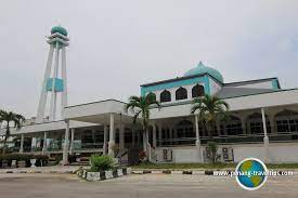 The mosque is brown in colour with wide screen windows and a minaret. Masjid Jamek Seberang Jaya