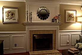 Elegant, empty golden frame inside molding on a gray wall of a stylish living room interior with lamp and a plant. Wood Panelling Fireplace Novocom Top