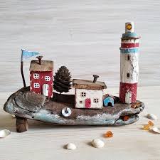 Ready For Shipping Old Fishermens Houses And Lighthouse This Rustic Fishing Vintage Village Is Framed By Small Shiny Piec Nautical Crafts Crafts Driftwood Art