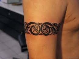 Other than the appeaking thick black curves just below the chest, the tribal band on the waist and the sun above the navel, all synchronize work to create a breathtaking piece of art. 61 Ultimate Band Tattoos On Arm