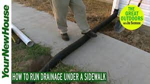I have a water leak under slab cement in my driveway which is making it's way into my garage now as well. How To Run Wires Or Drainage Under A Sidewalk Or Driveway The Great Outdoors Youtube