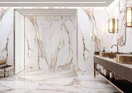 This tile features elegant white tones with a splash of grey and streaks of gold. Calacatta Gold 24 X 48 Cerrad