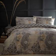 An updated paisley pattern is vibrantly showcased with an eclectic mix of floral prints and medallions while matching sham(s) harmonize with the colorful pattern seen on top of the bed. Bali Tribal Paisley Print Reversible Natural Duvet Cover Set Ideal Textiles