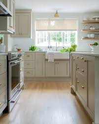 Modern farmhouse kitchen with alabaster and naval shaker cabinets. Tan Shaker Kitchen With Farmhouse Sink Transitional Kitchen