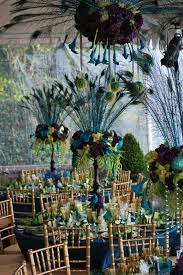 Long, colorful and graceful peacock feathers and plumes guarantee that any peacock themed room will showcase your decorating talent. Pin By Rachel Swimmer Flores On Wedding Of The Century Peacock Wedding Centerpieces Peacock Wedding Theme Peacock Wedding Decorations