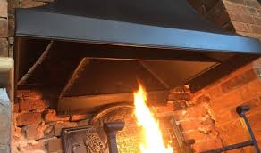 Canopies And Fire Hoods Camelot Fireplace Open Fire Canopies A slim, boxed hood above conceals a canopy and the stainless steel flue is exposed.