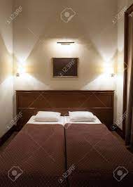 In this layout, two beds rest opposite one another with a desk between both of them. Bedroom Two Beds Luxury Bedroom Sleeping Suite Hotel Room Stock Photo Picture And Royalty Free Image Image 88628770