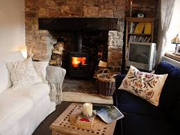 Design ideas for a contemporary living room in london with blue walls, medium hardwood flooring, a standard fireplace and brown floors. Small Cottage Living Inspiration House Plans