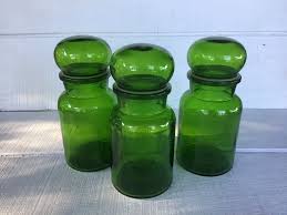 Our glass apothecary jars are great for a number of uses ranging from making your own candles to simply using them for decorative storage. Set Of 3 Vintage Emerald Green Jar Bubble Lid Vintage Glass Etsy Vintage Green Glass Vintage Glass Bottles Glass Apothecary Jars