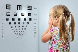 Little Girl Looking At Vision Test Chart Stock Photo