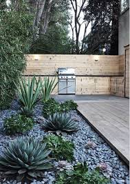 Gorgeous Minimalist Garden With Agave And Hosta Plants And Bbq Kitchen Outdoorkitchen Bbq Al Rock Garden Landscaping Landscaping With Rocks Outdoor Gardens