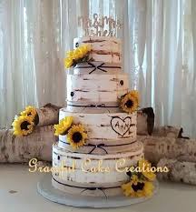 Birch Tree Wedding Cake With Sunflowers Rustic Birch Bark Wedding Cake Accented With Burlap And Lace And Sunflowers Country Wedding Cakes Sunflower Wedding Cake Sunflower Themed Wedding