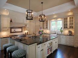 The White Cabinets Here Are Definitely Elegant And When Paired With The Uba Tuba Gra Granite Countertops Kitchen Cream Colored Kitchen Cabinets Granite Kitchen