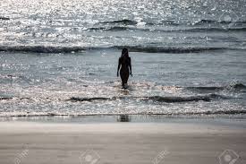 Beautiful Silhouette Of A Naked Girl Emerging From The Sea At Sunset Stock  Photo, Picture And Royalty Free Image. Image 121418793.