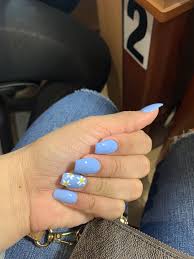 The blue shade used is one of our favorites because it is so vivid and bright. Daisy Design With Light Blue Background Baby Blue Acrylic Nails Blue Acrylic Nails Acrylic Nails Coffin Pink