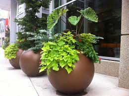 Round up old outgrown rain boots, toy trucks, or laundry baskets and make fun planters out of them together. 16 Round Planters Ideas Planters Round Fiberglass Planters