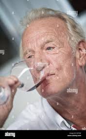 John Button, father of British Formula One driver Jenson Button of McLaren  Mercedes, drinks a glas of red wine in the paddock at the Autodromo Jose  Carlos Pace in Sao Paulo, Brazil,