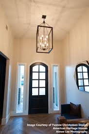 Consider using a hanging lantern in your foyer when a chandelier would simply be too large for the space. The Brook Hall Collection Is Simplistic In Design But Accented Impeccably The Western Bronze Finish Large Foyer Chandeliers Foyer Chandelier Foyer Decorating