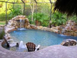 Here's a backyard with a darker water color made to look like a natural river pool. Natural Swimming Pool Enclosed Very Nice Enclosure To This It Doesn T Detract From Indoor Swimming Pool Design Swimming Pools Backyard Indoor Pool Design