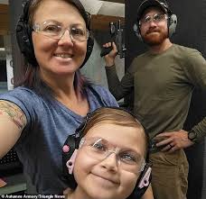 Girl, eight, tests rifles, handguns and even a flamethrower