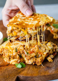 Place two tortillas, buttered side down, on a griddle; Chicken Quesadillas Gimme Delicious