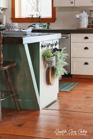 We wanted the cabinets to complement our current gray we had an open wall in our kitchen and needed some extra cabinet storage. Log Cabin Kitchen With Blue And Green Decor Creative Cain Cabin