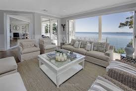 The home is spacious and elegant, with a screen covering an extensive side of the structure, filtering light and creating a lovely pattern of swirling shadows on nearby surfaces. Untitled Coastal Style Living Room Coastal Decorating Living Room Beach House Interior