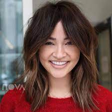 The bangs are worn long and swept to one side, framing the face in charming layers. Proof That Face Framing Layers Are The Most Flattering Thing Ever Southern Living