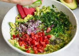 Smashed Avocados Diced Tomatoes Red Onion Minced Cilantro Garlic Jalapeno And Lime Juice In Bowl Making Guacamole Guacamole Recipe Homemade Guacamole Guacamole