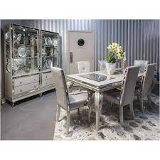 The dining room group features a rectangular dining table supported by two very detailed metal pedestals, and lushly upholstered seating. 9001600t 104 Aico Furniture Hollywood Loft Frost Dining Table