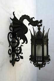A fabulous wall lamp created for an outdoor use. Black Wrought Iron Dragon Lanterns For Either Indoor Or Outdoor Lighting Gothic House Gothic Furniture Gothic Decor