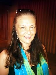 Deaf person with green eyes wearing hearing aids