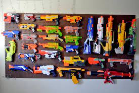 It is a peg board that has been transformed into a great space to hold nerf guns and all that comes with them. Behold 13 Clever Nerf Gun Storage Ideas Mum Central