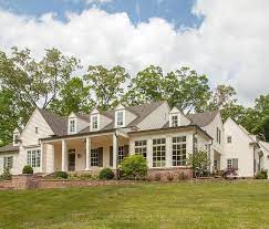 Flat cottage residential apartment architecture. This Beautiful Traditional 2 Story Farmhouse Features White Siding A Front Porch With Columns A Bottom Bri Brick Farmhouse Brick Ranch Houses Farmhouse Plans